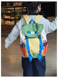 Detail of multi-color color-block children backpack with adjustable blue nylon straps