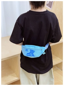 Blue kids chest bag with cartoon bear print and adjustable strap shown on child back