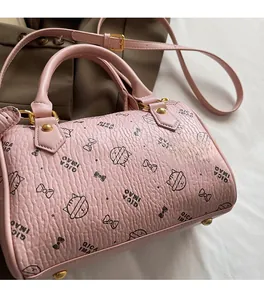Detail of pink cat print Boston bag in lychee texture leather with golden hardware