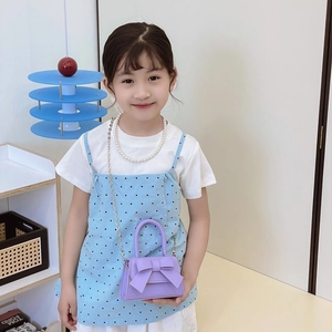 Mini lavender girl's crossbody bag with elegant bow decoration and silver chain strap