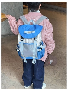 Detail view of children backpack with blue beige color block design and adjustable straps