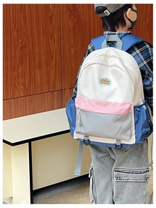 Close-up of kids colorful color-block backpack with adjustable straps and logo detail