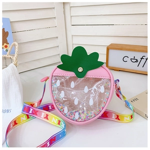 Close-up of strawberry-shaped kids bag featuring clear window with colorful sequins