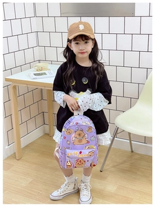 Close-up of purple grid backpack featuring cute cartoon Capybara patterns and durable canvas