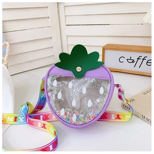 Detail view of purple strawberry kids bag with colorful sequins and rainbow strap