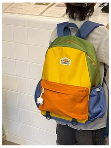 Multi-colored nylon backpack for kids featuring large compartments and side water bottle pockets