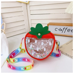 Detailed view of kids strawberry bag with glitter sequins and rainbow strap