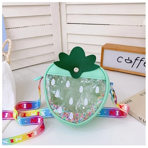 Detail of mint green strawberry glitter bag with rainbow strap and transparent PVC window