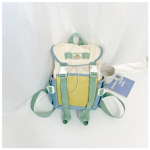 Detail of color-block kids backpack with buckle closure and drawstring in canvas fabric
