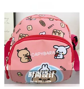 Close-up of pink children crossbody bag with cute capybara print and adjustable strap