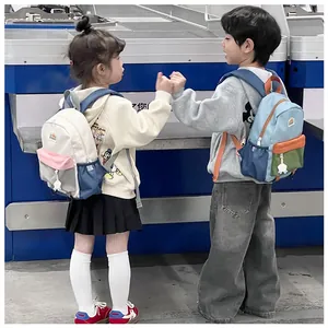 Rear view of vibrant color-block backpacks for kids featuring multi-pocket design