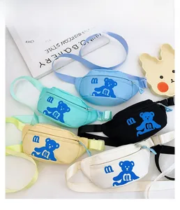 Flat lay of colorful cartoon bear waist bags with adjustable straps in five vivid colors
