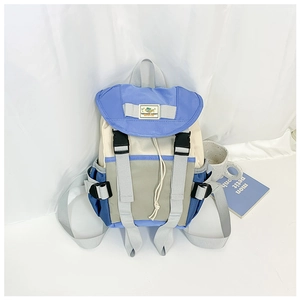 Detail of color-block kids backpack with buckle closure and durable nylon material