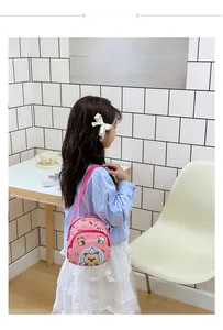 Pink kids crossbody bag featuring cute cartoon capybara print and floral side details