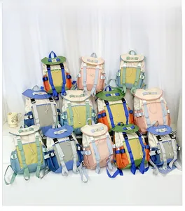 Detailed stack of multi-color nylon school backpacks with drawstring flap and buckles