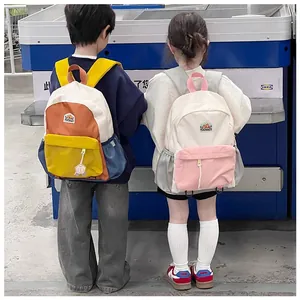 Detailed comparison of two color-blocked children's backpacks with heart charms and zippers