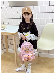 Pink cartoon capybara backpack shown on girl in a bright minimalist interior