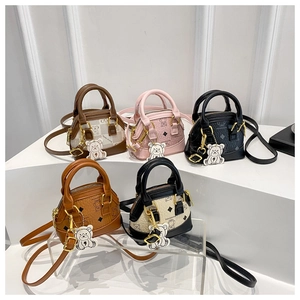 Mini shell bags for kids featuring cute bear embossing and colorful charms in various colors