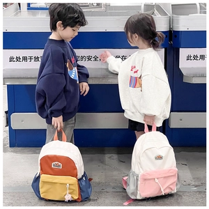 Detail of color-block canvas kids backpacks with side pockets and zipper closure