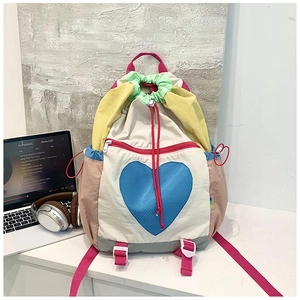 Detail of colorful drawstring backpack showing heart print and multi-color patchwork design