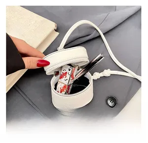Detail of white litchi leather mini bucket bag showing interior storage capacity