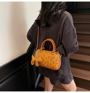 Boston barrel bag detail showing brown PU leather with cute cat print and cat charm