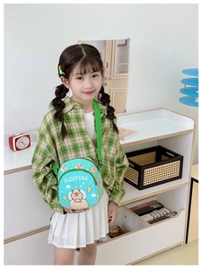 Detail of mint green kids crossbody bag with cartoon capybara print and adjustable strap