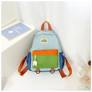 Detail of multi-color block kids backpack featuring peak logo patch and cute badge charm