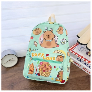 Detailed view of the Capybara cartoon print and front zipper pocket on a green kids backpack