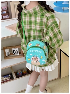 Adjustable green strap and sleeping capybara print on a cute kids crossbody bag