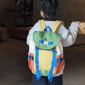Colorful patchwork nylon backpack for kids with adjustable blue straps and buckle