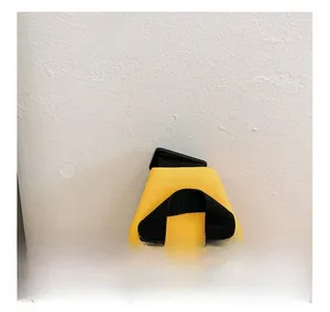 Detail view of the yellow chest bag showing the durable black nylon carry handle and clasp