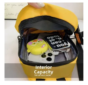 Detail view of large internal capacity of the yellow kids chest bag with items