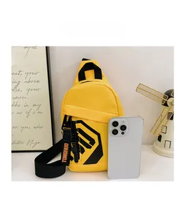 Detail of yellow nylon chest bag for kids featuring printed patterns and shoulder strap