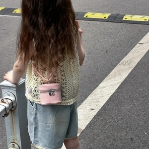 Pink mini cylinder shoulder bag for girls with textured finish and woven strap