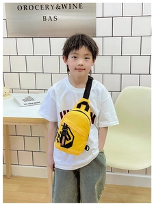 Detail of a bright yellow canvas chest bag for kids with black geometric prints