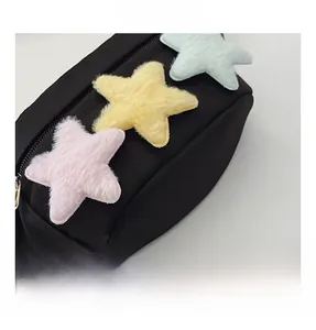 Détail du sac de poitrine en toile avec étoiles en peluche et fermeture éclair