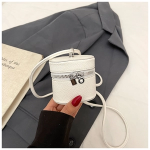 Close-up of white lychee leather mini bucket bag with silver zipper and padlock detail