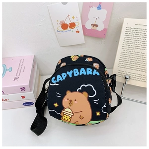 Detail of black crossbody bag featuring cartoon Capybara print and adjustable strap