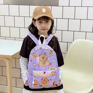 Purple Capybara cartoon kids backpack for elementary school students on a young model