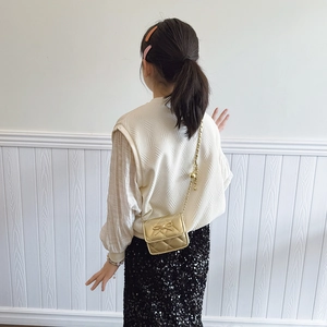 Girl's metallic gold quilted crossbody bag with sweet bow and gold chain strap