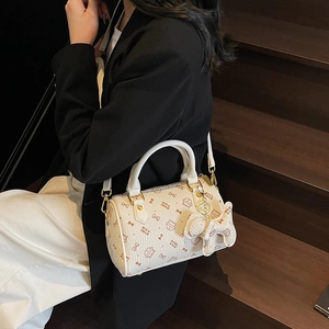 White Boston bag with cat and bow print, gold hardware, and detachable shoulder strap