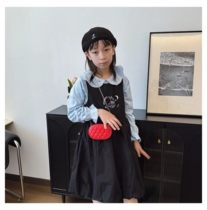 Detail of red quilted chain crossbody bag for kids styled with stylish autumn outfit