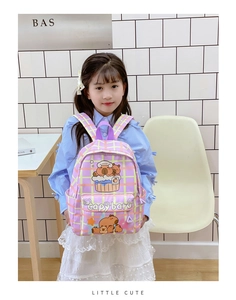 Close-up of purple plaid school bag featuring cute capybara prints and durable canvas fabric