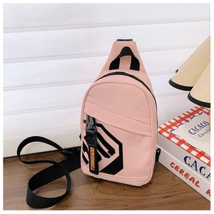 Detailed view of pink nylon chest bag with black geometric print and adjustable strap
