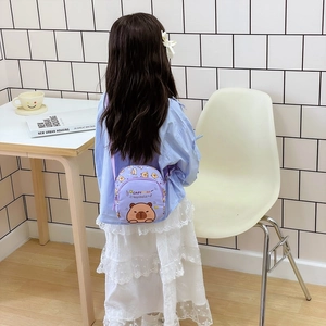 Child wearing purple round Capybara crossbody bag with adjustable strap and cute print