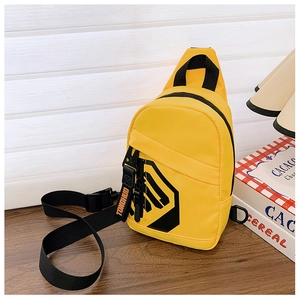 Detail of yellow sports chest bag for boys with geometric camo print and letter charm