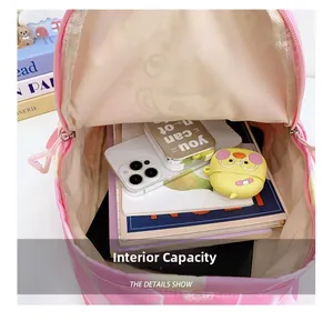 Internal view of the pink backpack showing large capacity for books and electronics