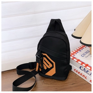 Detail of black nylon kids chest bag with orange logo and adjustable shoulder strap