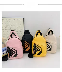 Detail showing colorful kids chest bags with front zippers and branding on white surface